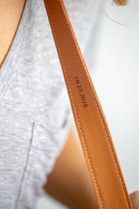 FOTO | The Designer in Saddle - a saddle brown genuine pebbled leather camera strap that can be personalized with a monogram or business logo, making this leather camera strap the perfect personalized gift.